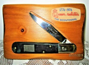 The Single-bladed Daddy Barlow 1976 bicentennial knife on a pine wall display 